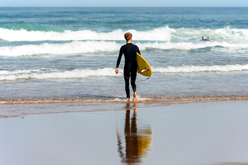 surfer going into the sea