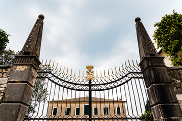 Fototapeta premium Classic stately door with coat of arms at the entrance of an Italian villa.