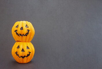 Two Stacked Wax Jack o Lantern Orange Candles and Black Background