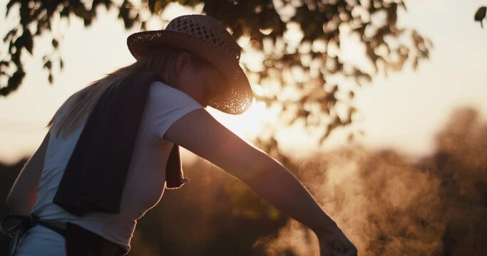 Woman cook outdoors female chef evening sun light lens flares