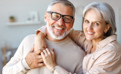 Beautiful smiling senior family couple husband and wife looking at camera with love