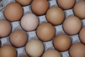 pile of chicken eggs in large quantities on a paper tray
