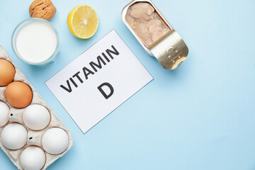 Text VITAMIN D and different healthy products on blue background