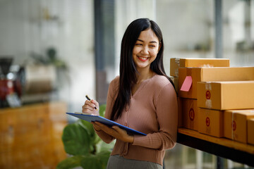 Portrait of Starting small businesses SME owners female entrepreneurs working on receipt box and...