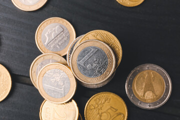 Golden coins on dark wooden background