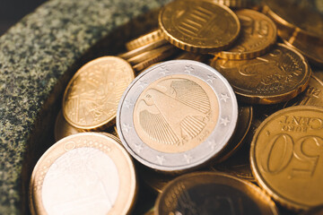 Bowl with golden coins, closeup