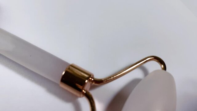 White massage quartz roller for the face close-up isolated on a white background
