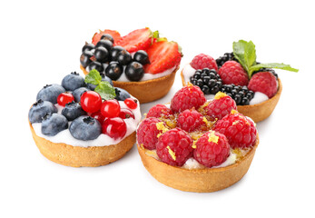 Tasty berry tartlets on white background