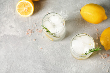 Glasses of cold gin tonic on grey background