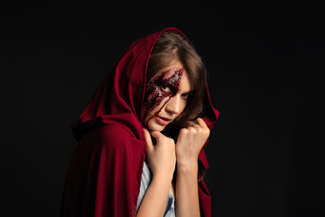 Young woman with Halloween makeup on dark background