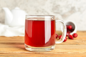 Glass cup of natural dogwood drink on table, closeup