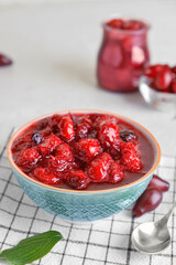 Bowl of delicious dogwood jam on table