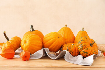 Different ripe pumpkins on wooden table