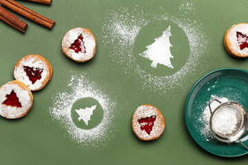Tasty Linzer cookies with icing sugar on color background