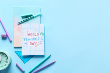 Concept of Teacher's Day. School supplies and greeting card on blue background, top view