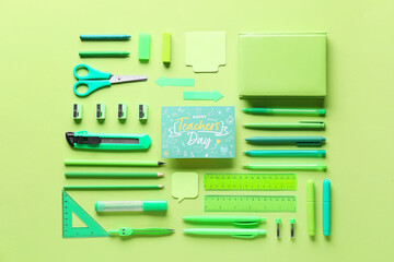 Teacher's Day concept. School supplies and greeting card on green background, top view