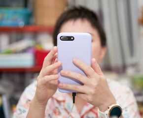 woman using phone camera to take picture and images