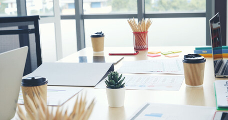 Meeting room Office laptop business financial document chart , graph on wooden table with coffee cup. Flat lay notebook computer laptop on office desk. No people business graph chart on meeting table