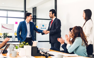Image two asian business partners successful handshake together in front of group teamwork casual...