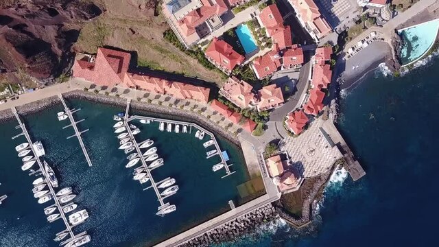 Aerial view of Quinta do Lorde small village hotel on the coast of the Portuguese island of Madeira with a small yacht harbour