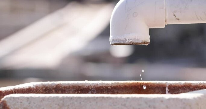 Water Drops Dripping From An Open Water Line. Water Wastage Concept. close up