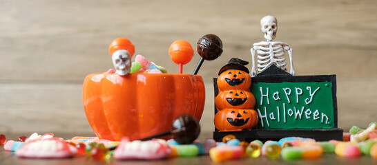 Happy Halloween day with ghost candies, pumpkin bowl, Jack O lantern and decorative (selective focus). Trick or Threat, Hello October, fall autumn, Festive, party and holiday concept