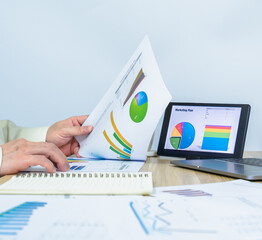 man working data graph document near notebook, tablet, laptop