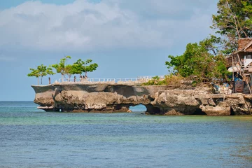 Acrylic prints Boracay White Beach Boracay, Philippines - Jan 25, 2020: famous landmark of Boracay island. A small rock in the sea. Tourists are photographed on the background of the white beach of the island.