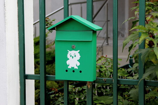 green mailbox with a picture of an owl
