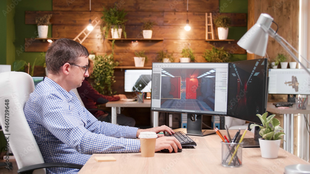 Poster game creator developing videogame simulation while working at level design using production software