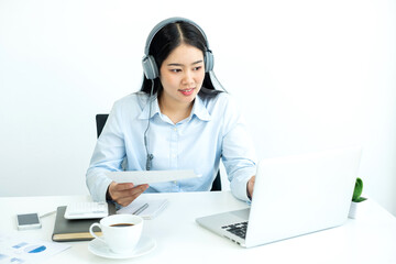 Asian female accountant sits at their desks and calculates financial graphs showing results about their investments, plan a successful business growth process