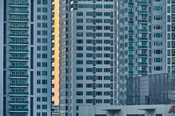Fototapeta na wymiar Manila, Philippines - Feb 01, 2020: evening view of the city of Makati. The skyscrapers against the bright setting sun.