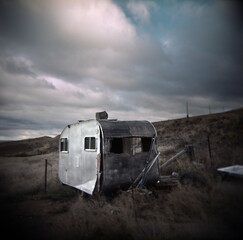 Old derelict caravan sitting abandoned in a rural paddock