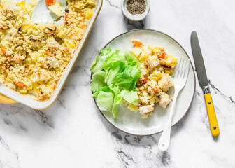 Savory crumble with cod and leek - a delicious lunch on a light background, top view