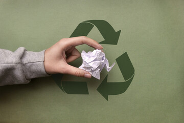 The man throws the crumpled paper into a garbage container. Sorting and recycling of garbage