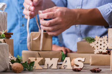Zero waste Christmas concept, father and son wrapping gifts