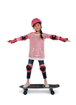 Asian little girl kid skateboarder with wearing safety and protective equipment stand on skateboard isolated on white background. Image with Clipping path.