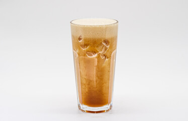 Iced coffee with milk and ice cube isolated white background.