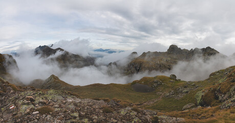 Alpine panorama with clouds in the valleys