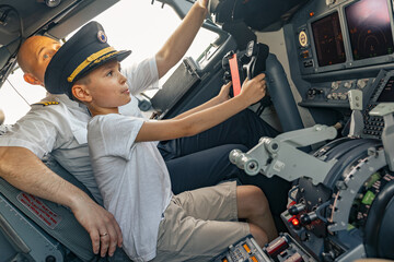 Child holding the steering wheel in the cockpit. Aircraft concept