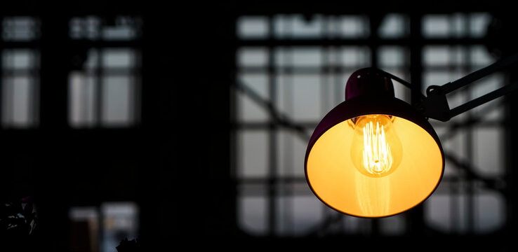electric  lamp on a window sill of the window.