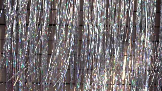 Festive video background. Shiny tinsel in silver and red moves and shines, 4k.