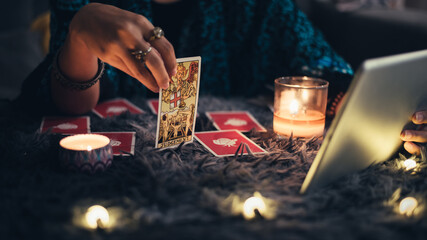 Fortune teller showing tarot cards online. Online tarot cards with tablet or smartphone....