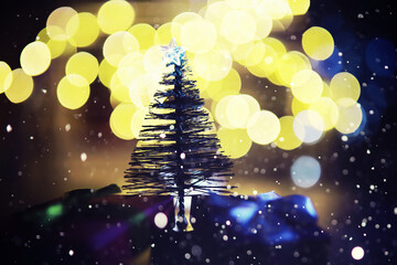 Winter holiday background with frozen fir, glitter lights, bokeh. Christmas and New Year holiday background with copy space.