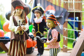 Children's party in a pirate style. Children in pirate costumes are playing on Halloween.