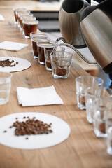 Barista pouring water to coffee cups