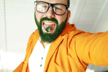A man with a green beard. St.Patrick 's Day. Irish fan color beard.