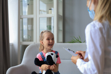 Doctor working with little patient in hospital.