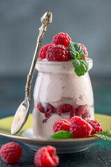 Healthy berry yogurt with fresh raspberries.