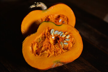 orange pumpkin in a cut on a wooden table